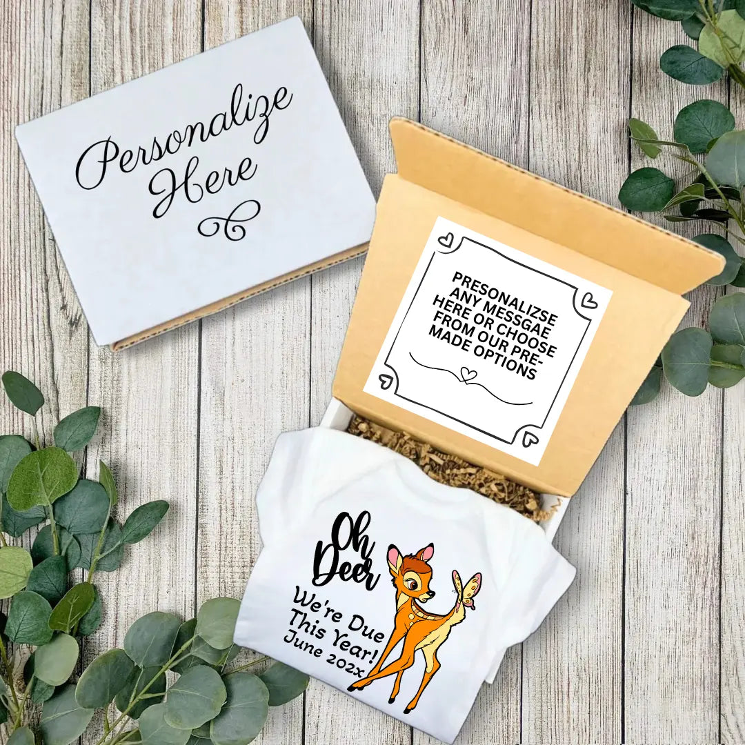 Personalized baby announcement item with deer design on a wooden surface