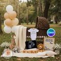 Baby shower setup with balloons, baby clothes, and toys outdoors.