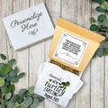 Personalized baby announcement towel with a box on a wooden surface