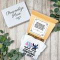 Personalized baby announcement towel with decorative box on a wooden surface