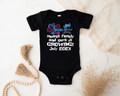 Black baby onesie with text and graphics on a light background
